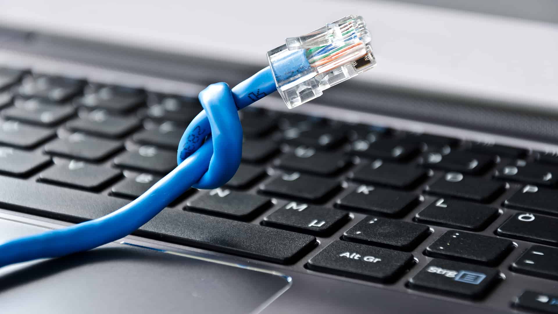 Twisted Ethernet cable on top of a laptop