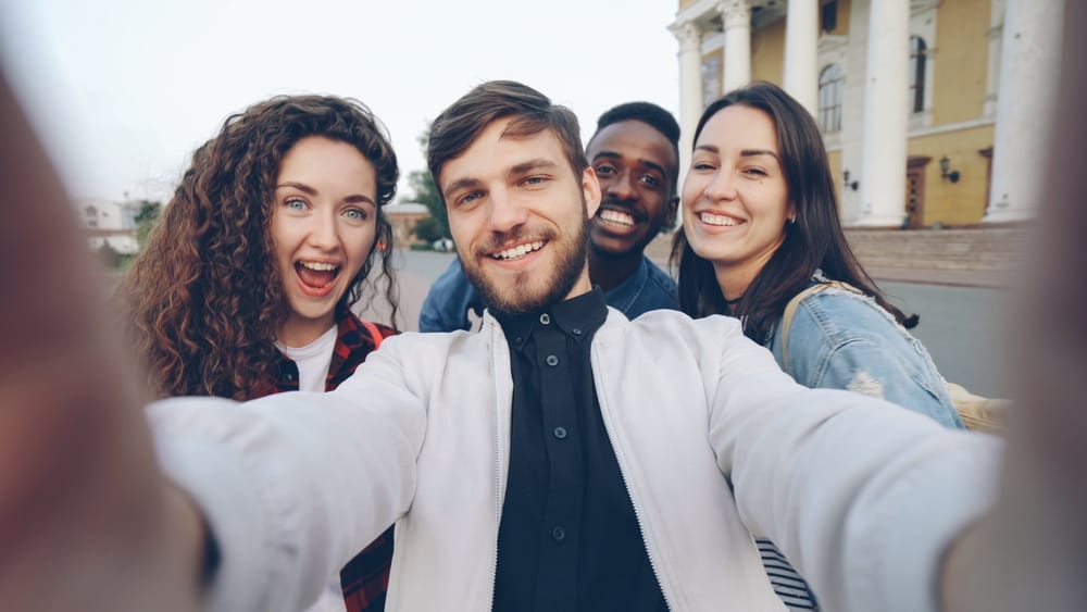 A group of friends takes a selfie together.