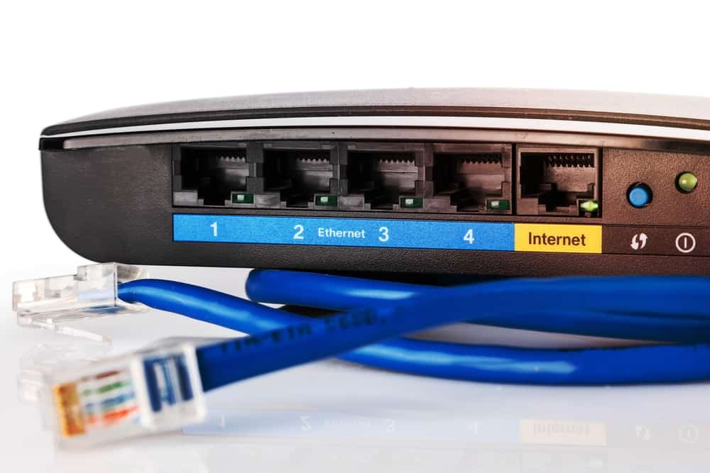 Ethernet ports on a modem-router with blue Ethernet cables