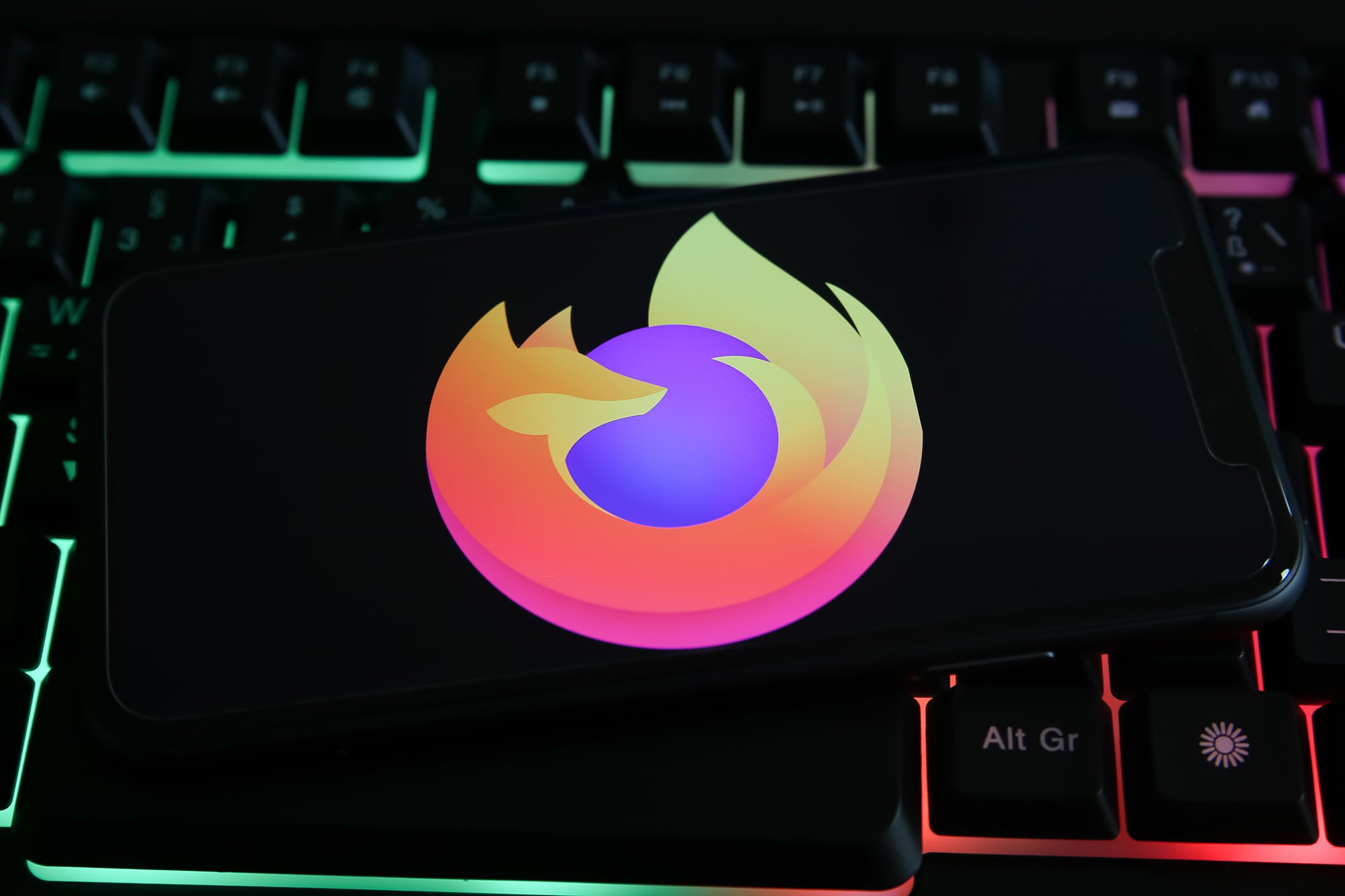 Mozilla Firefox logo on a phone sitting on a keyboard