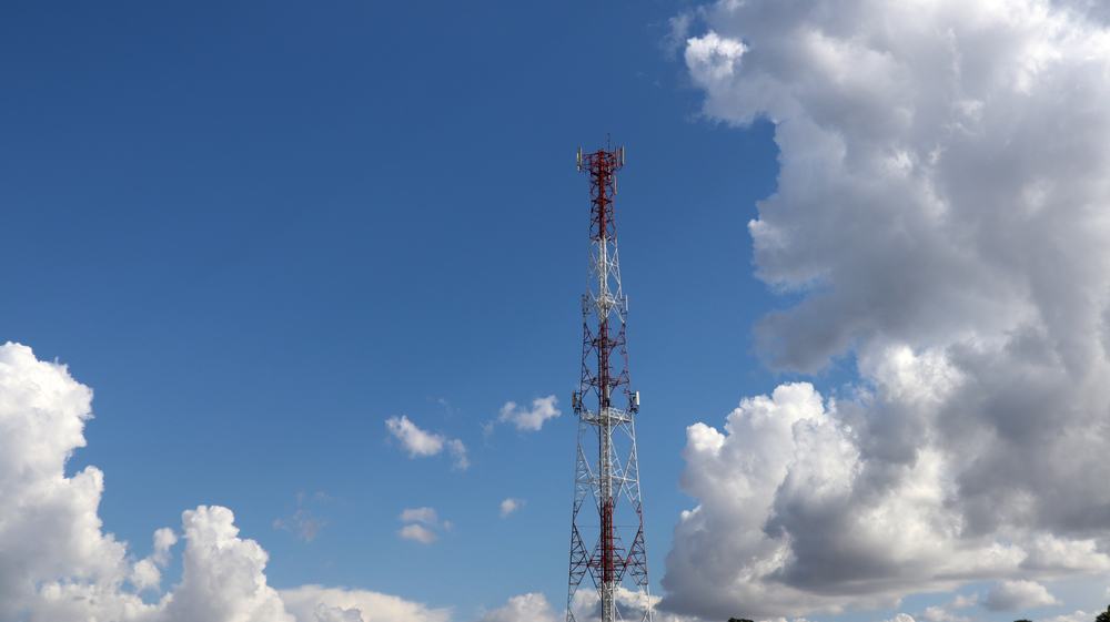 Telecommunication mast with clouds in the sky