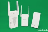 TP-Link RE715X, Asus RP-AX58, and TP-Link RE315 Wi-Fi extenders side by side on a green background