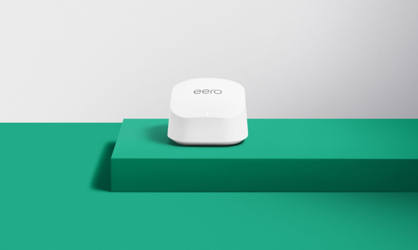 Image of the eero 6+ sitting on top of a green riser.