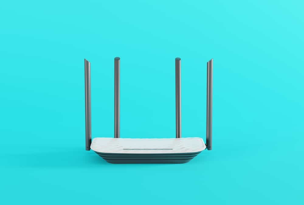 A white Wi-Fi router with four antennae