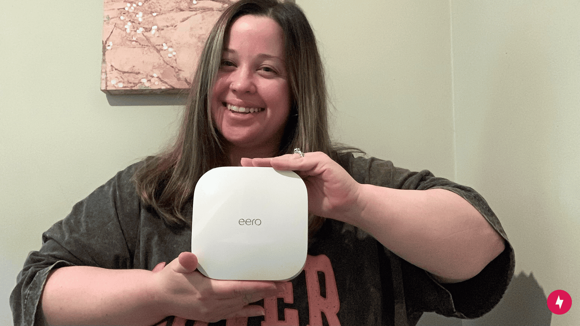 Reviewer Kate Fann holding the eero Pro 6 device