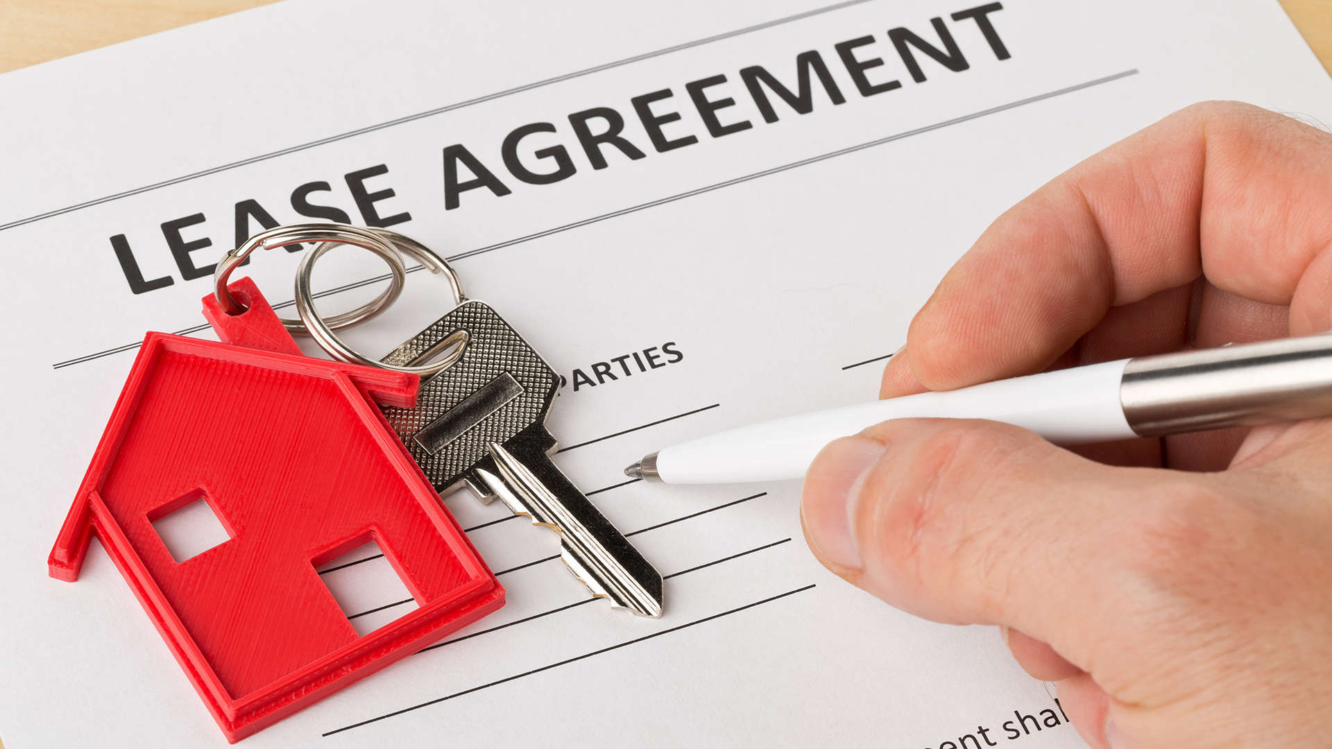  A person signing a lease agreement.