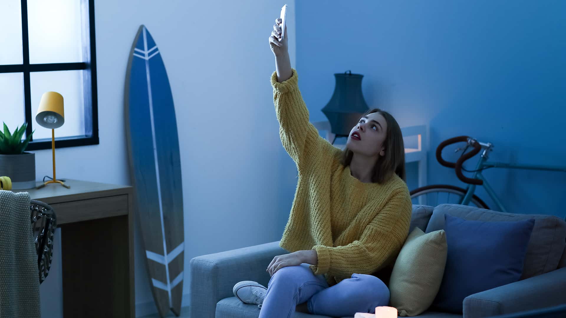 Woman holding up her smartphone in an attempt to get signal