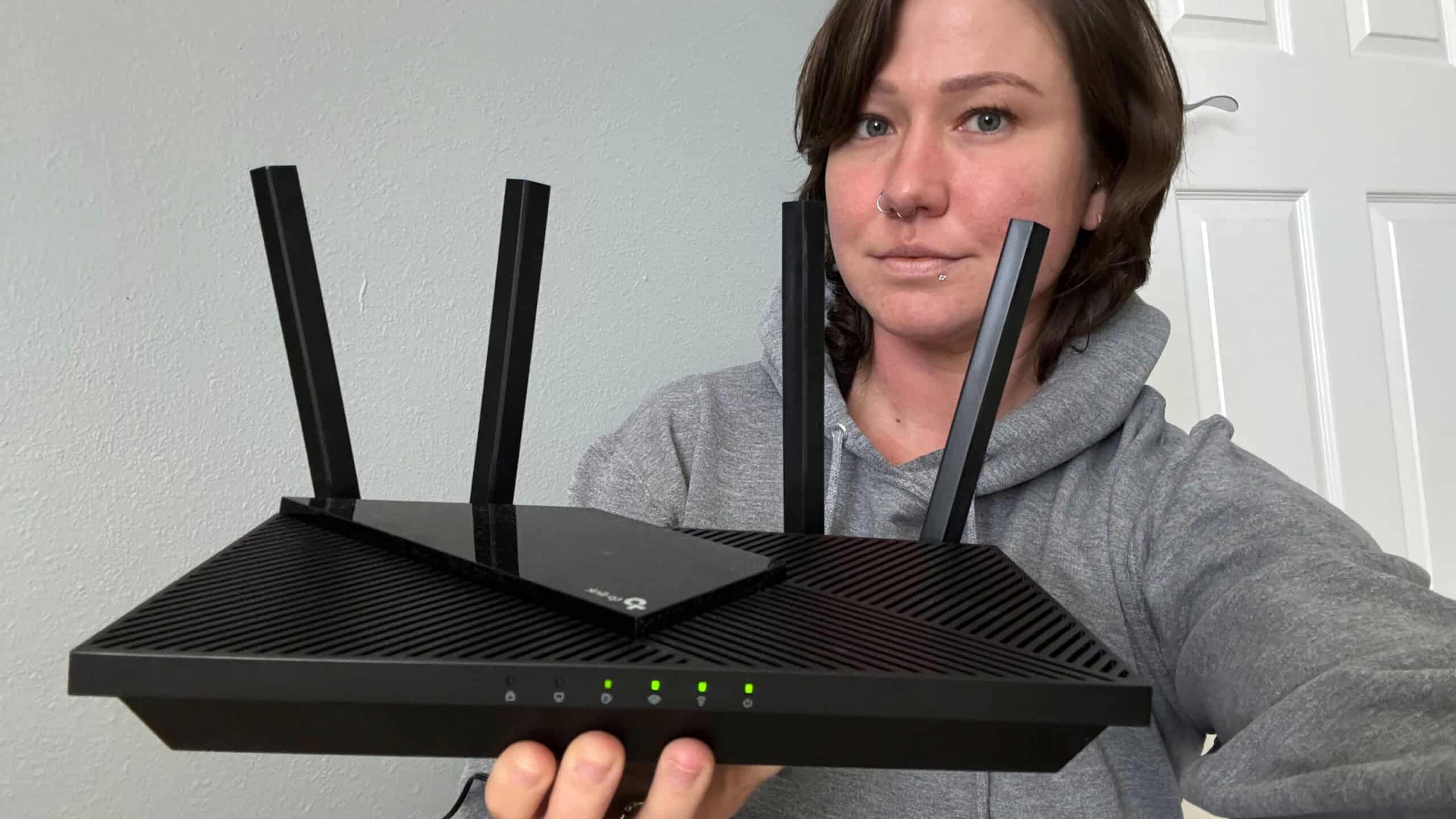 Bethany holding the TP-Link Archer router