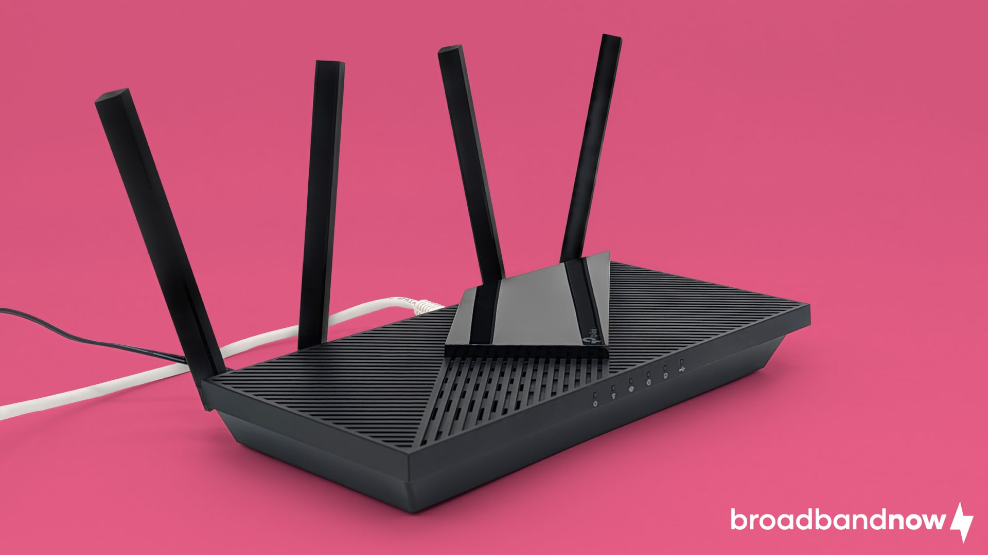 TP-Link AX55 Wi-Fi router on a pink background