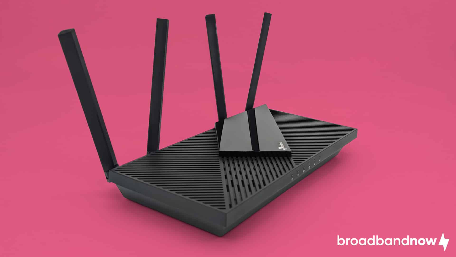 Photo of a TP-Link AX55 Wi-Fi router on a pink background