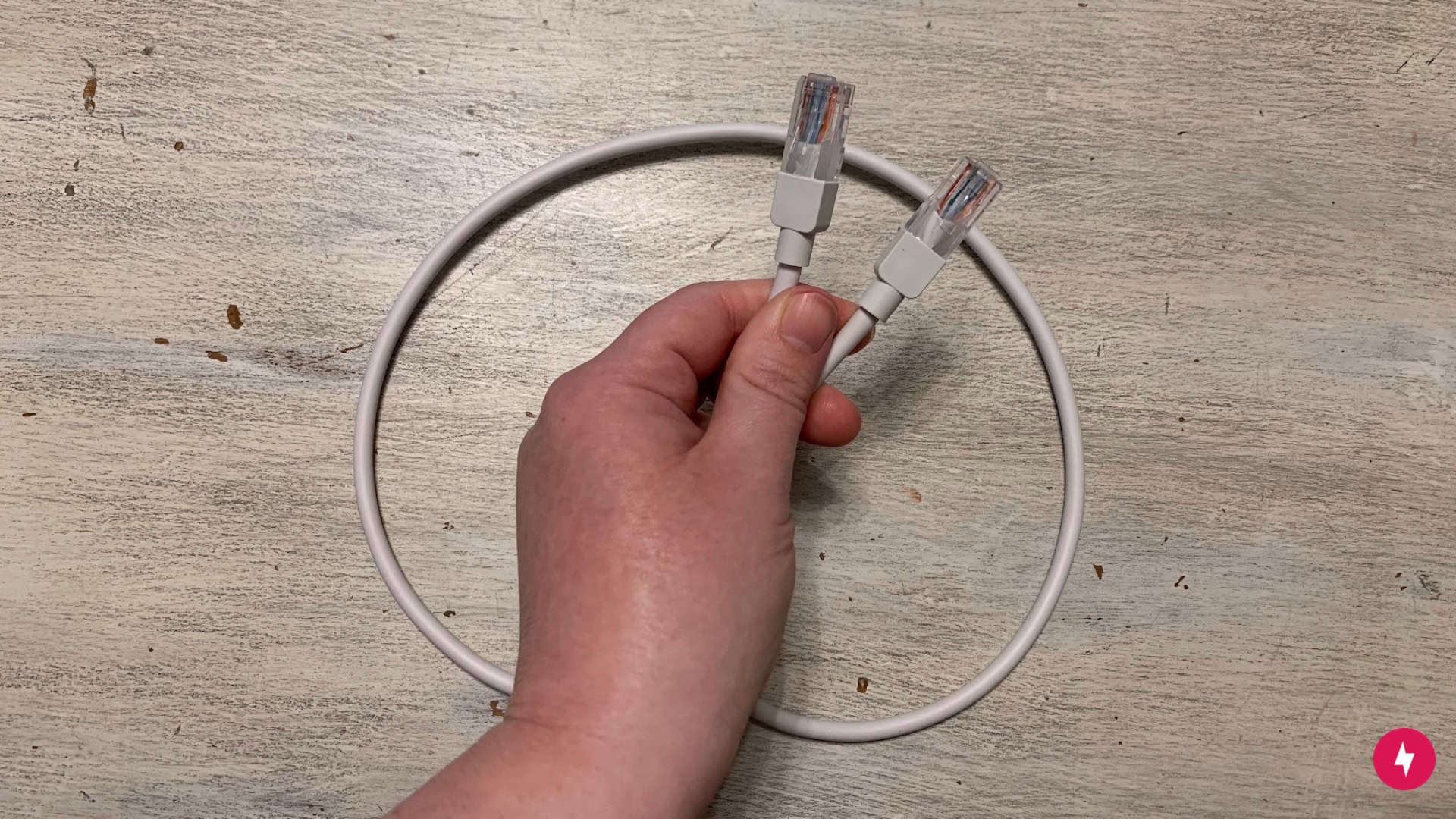 A white Ethernet cord with a focus on the end plugs.