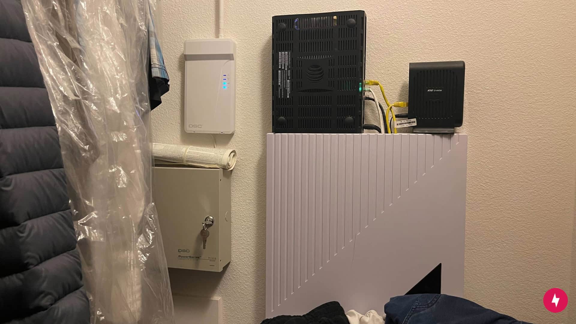 A modem and router placed in a closet.
