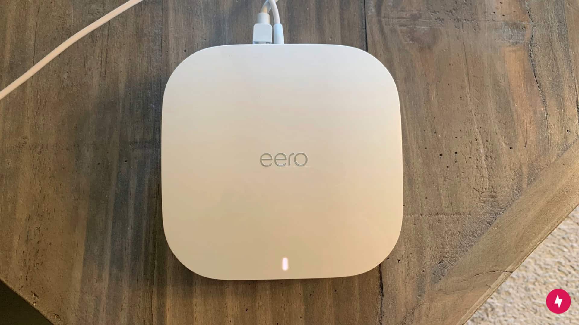 An Eero router with a solid white light to signify the internet is connected.