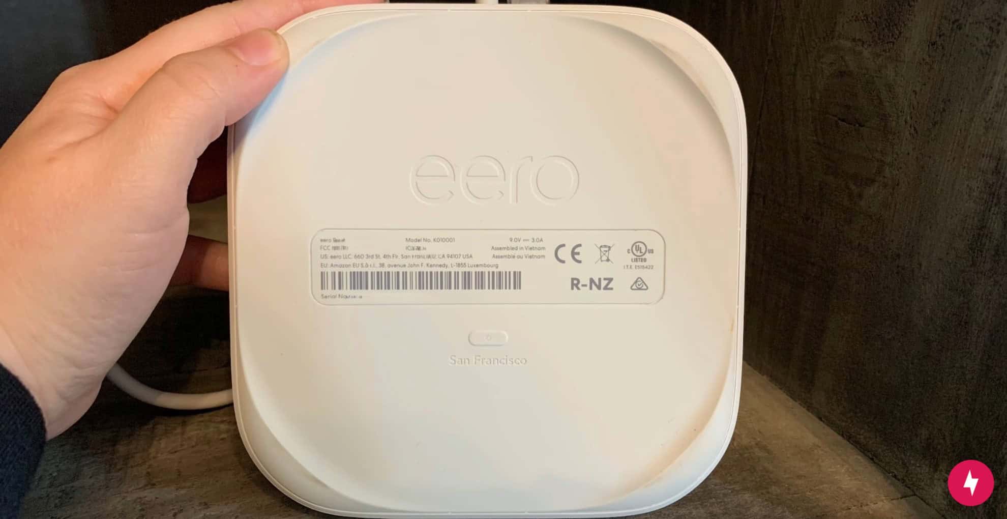The back of a white Eero Pro 6 device to show the location of the reset button.