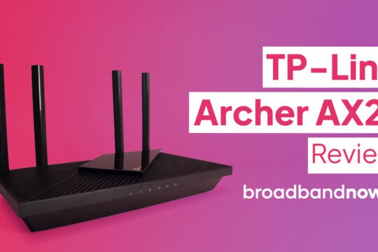 An angled view of the TP-Link Archer AX21 against a pink backdrop.