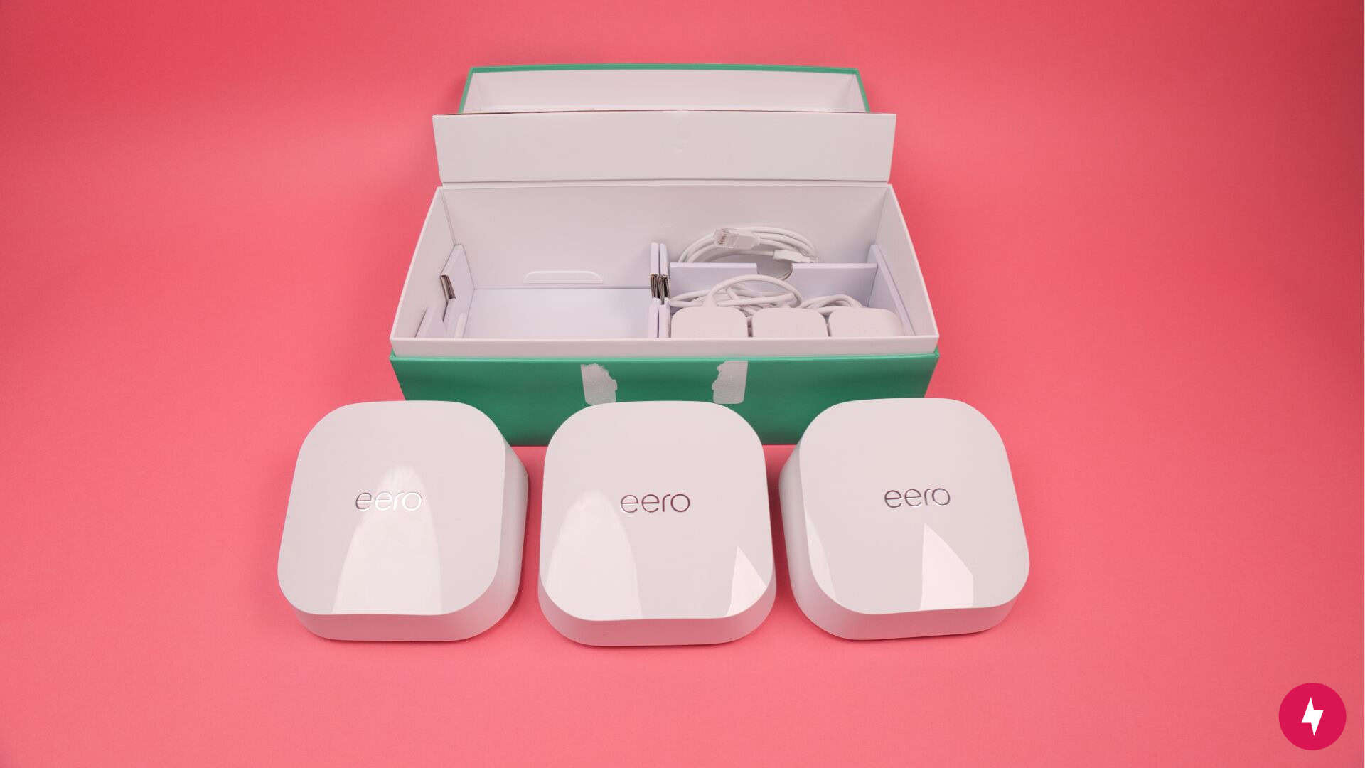 Three eero 7 nodes unboxed from their packaging.