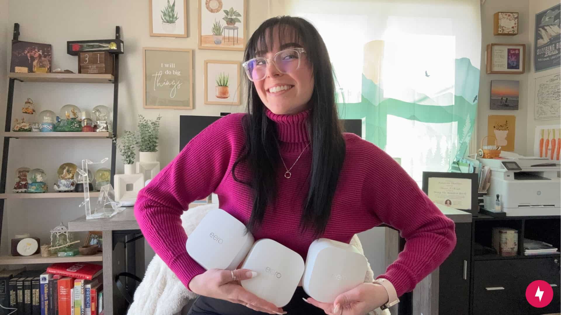 Hanna holding all three eero 7 nodes in her hands.
