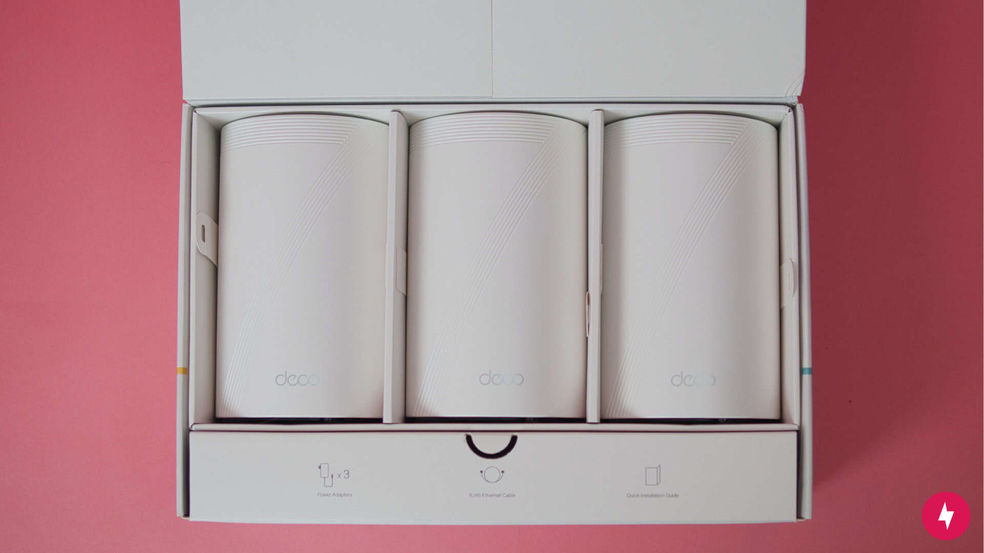 Three TP-Link Deco BE63 nodes in their packaging.