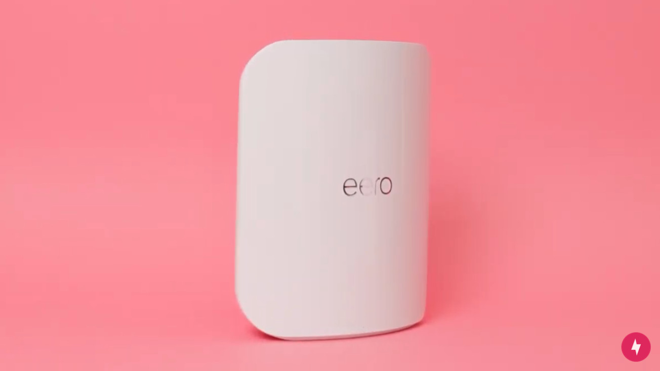 A white Eero Max 7 against a pink background.