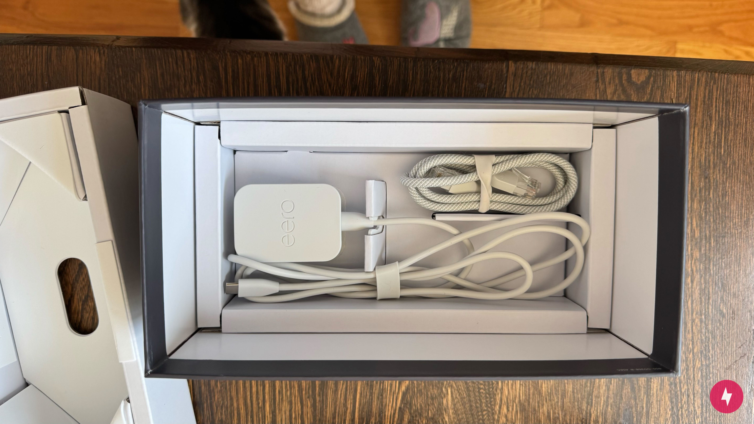 White cords for the Eero Max 7 arranged in a box.